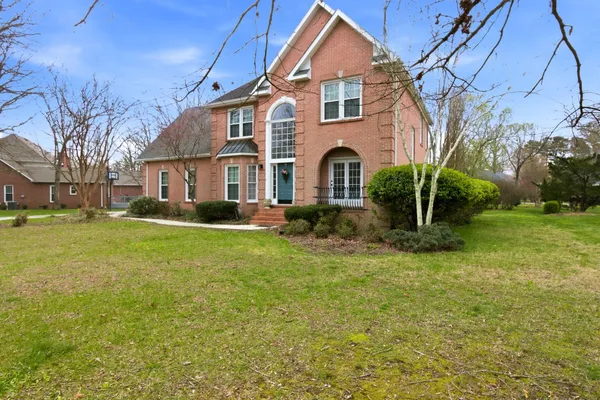 a front view of a house with a yard