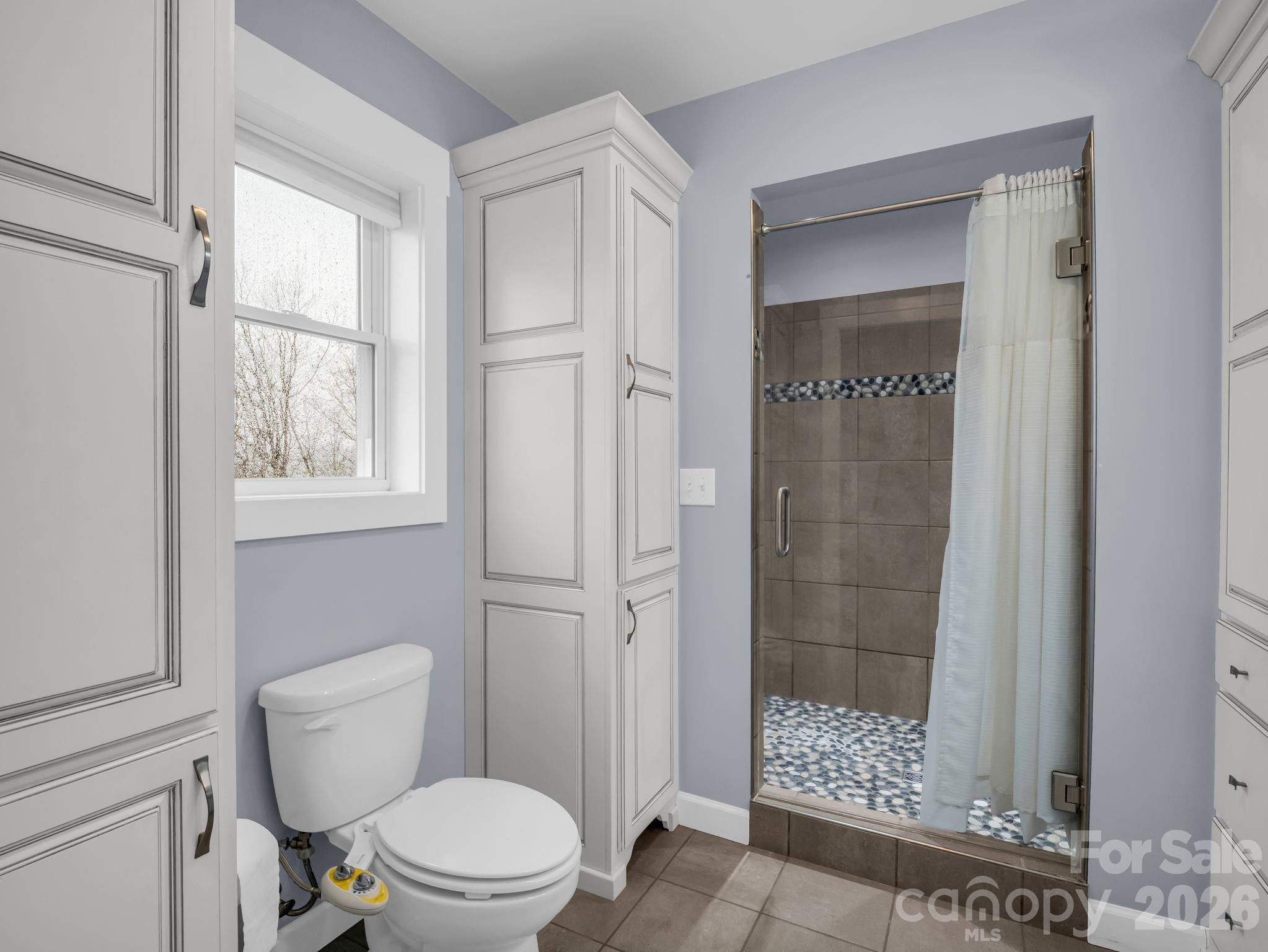 1086 Carters Ridge Road Spruce Pine, NC 28777 - Photo 21 of 48 a white toilet sitting next to a bathroom sink
