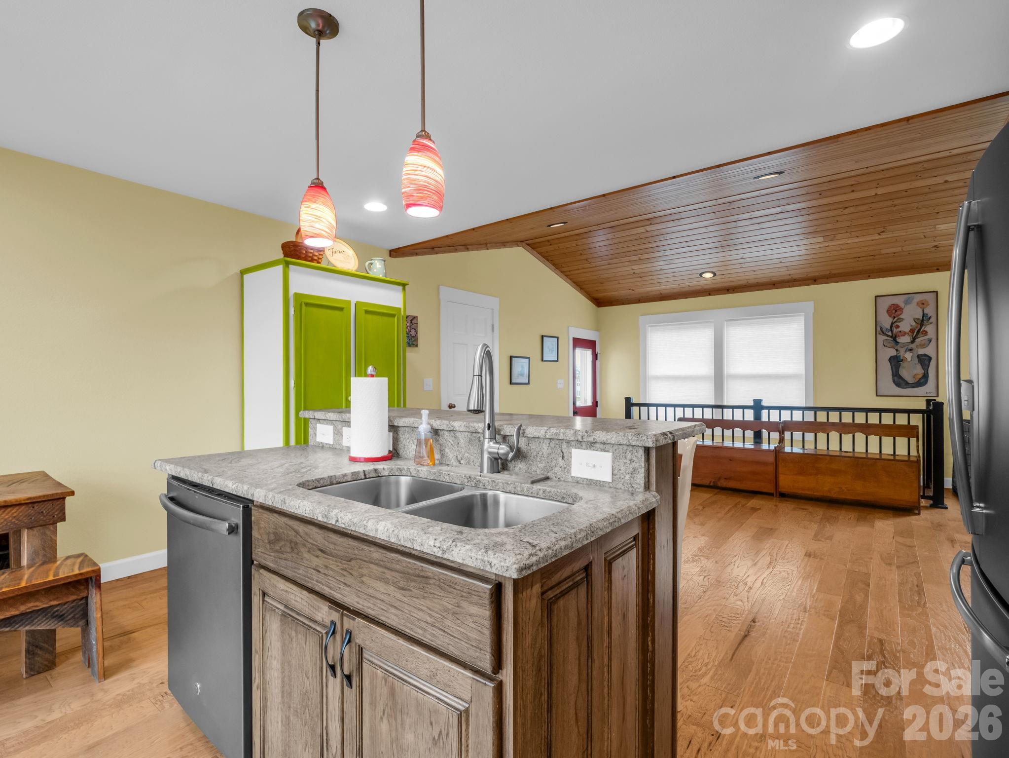 1086 Carters Ridge Road Spruce Pine, NC 28777 - Photo 28 of 48 a kitchen with a stove a sink a chandelier and a dining table