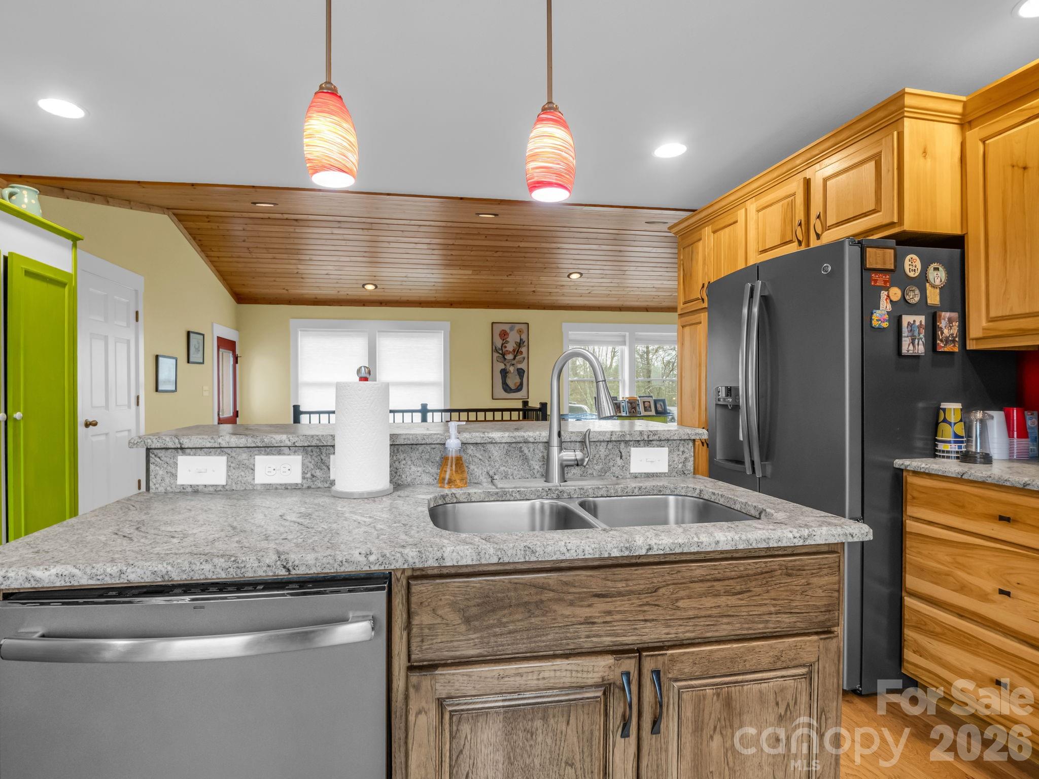 1086 Carters Ridge Road Spruce Pine, NC 28777 - Photo 30 of 48 a kitchen with granite countertop a sink and a refrigerator