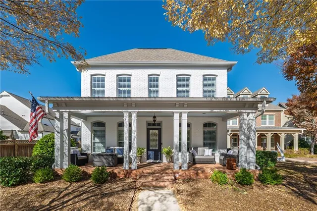 a front view of a house with yard patio and glass windows