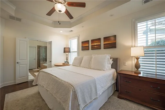 a bedroom with a large bed and a chandelier