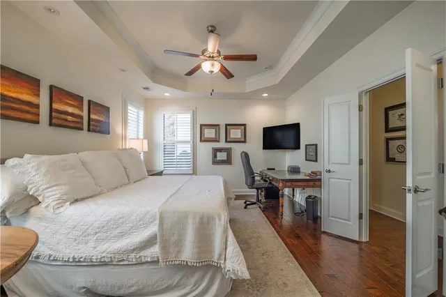 a bed room with a bed a television and a large window