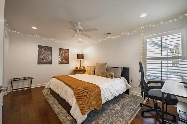 a bed room with a bed window and a chair