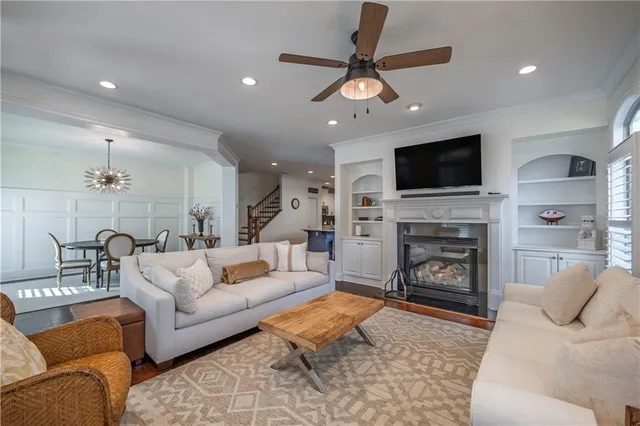 a living room with furniture a fireplace and a flat screen tv