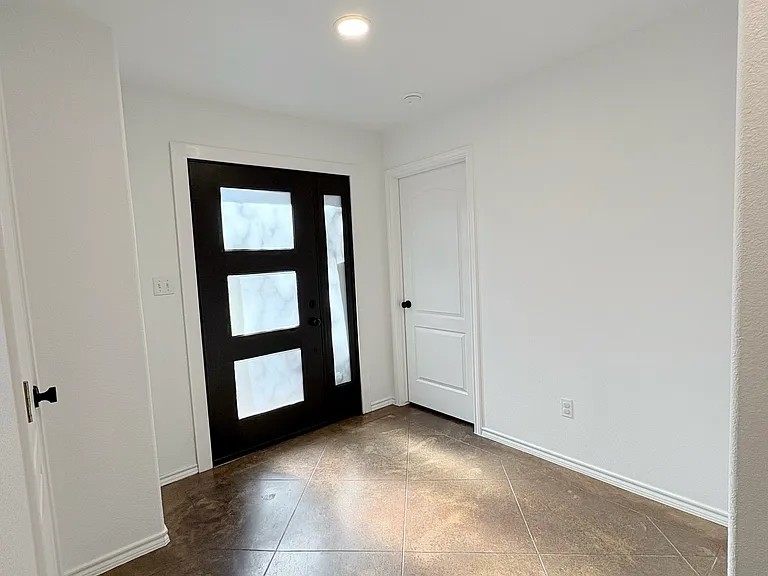 430 Summit Ridge Drive North Point Venture, TX 78645 - Photo 8 of 26 A welcoming entryway with sleek modern door designs and durable tile flooring.