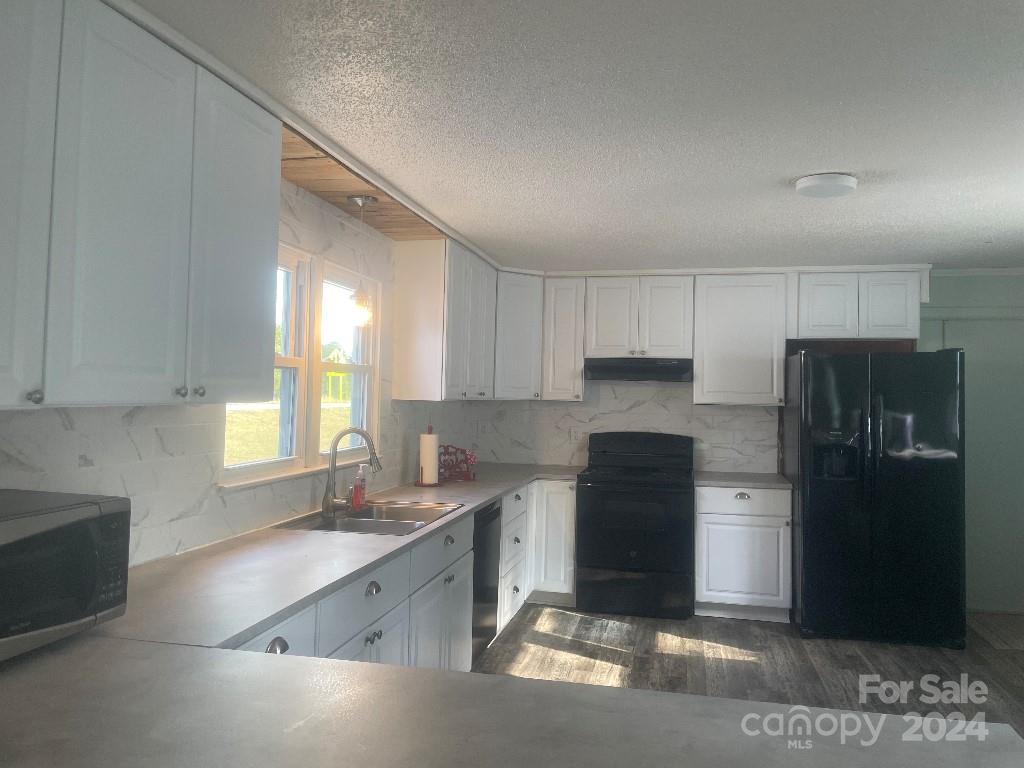 1329 Peach Orchard Road Union, SC 29379 - Photo 5 of 15 a kitchen with a refrigerator and a sink