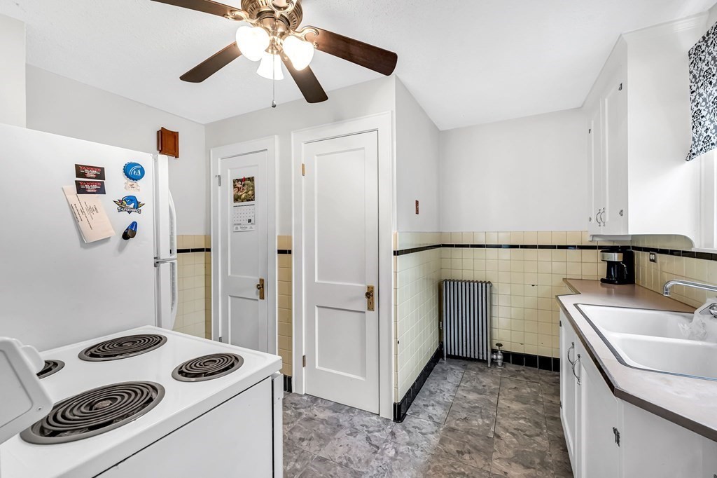 4 Ashbrook Street Springfield, MA 01118 - Photo 11 of 22 a kitchen that has a sink a stove and a refrigerator