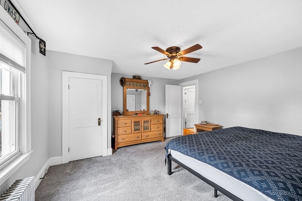 4 Ashbrook Street Springfield, MA 01118 - Photo 16 of 22 a bedroom with a bed and a chandelier