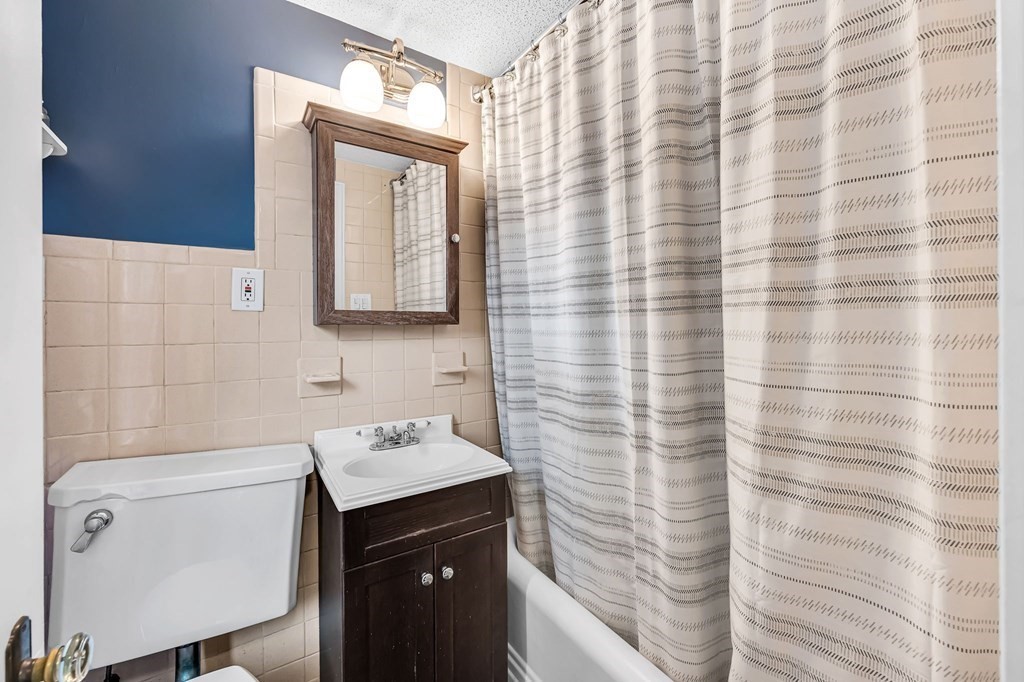 4 Ashbrook Street Springfield, MA 01118 - Photo 17 of 22 a bathroom with a sink a mirror and a shower