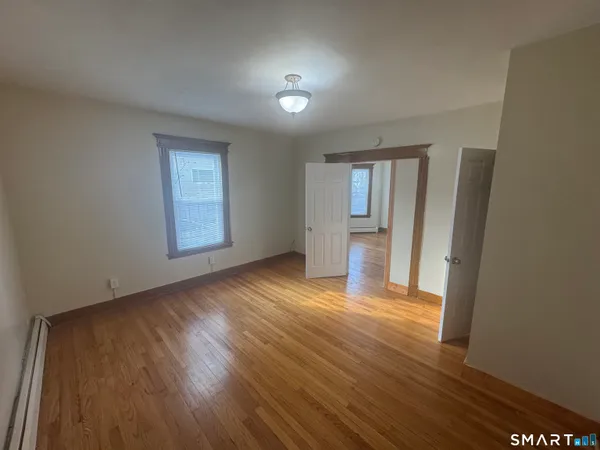 wooden floor in an empty room with a window