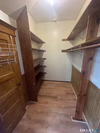 a view of walk in closet with empty racks