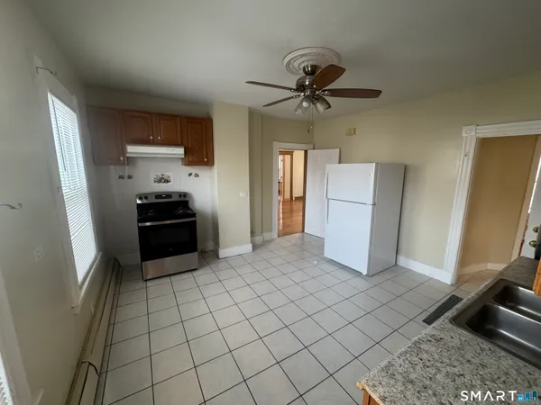 a kitchen with stainless steel appliances a refrigerator and microwave