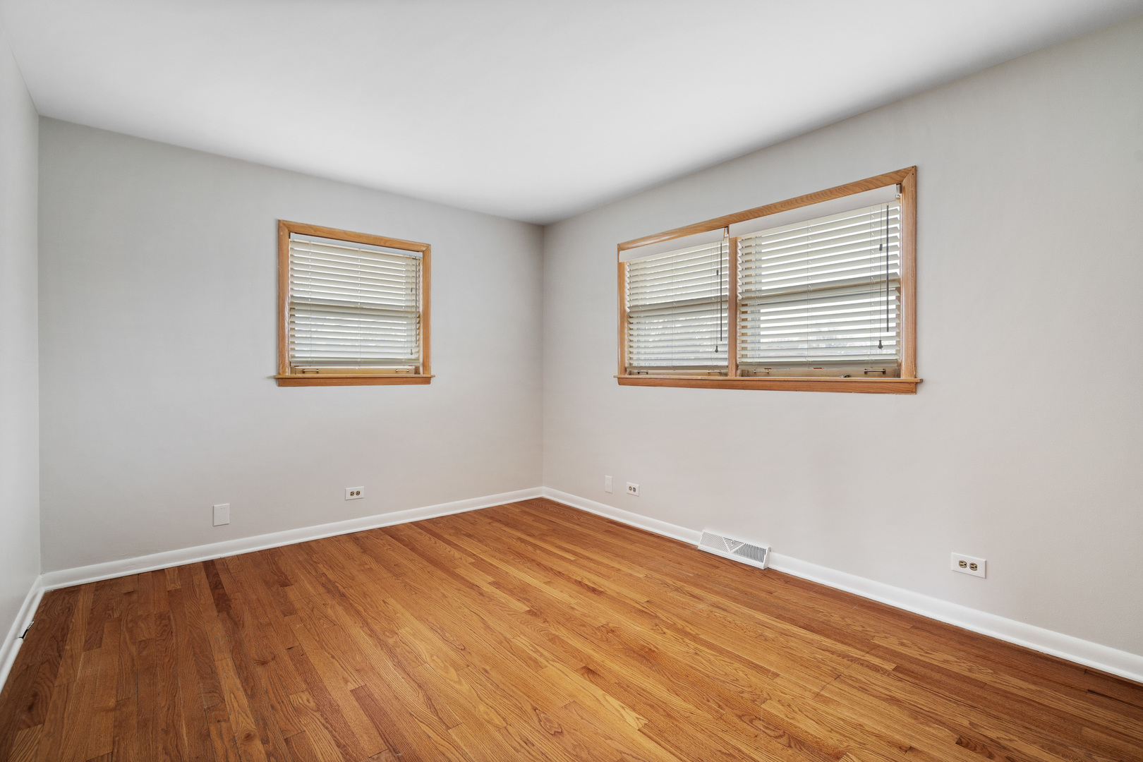 204 Dulles Road Des Plaines, IL 60016 - Photo 13 of 25 a view of an empty room with wooden floor and a window