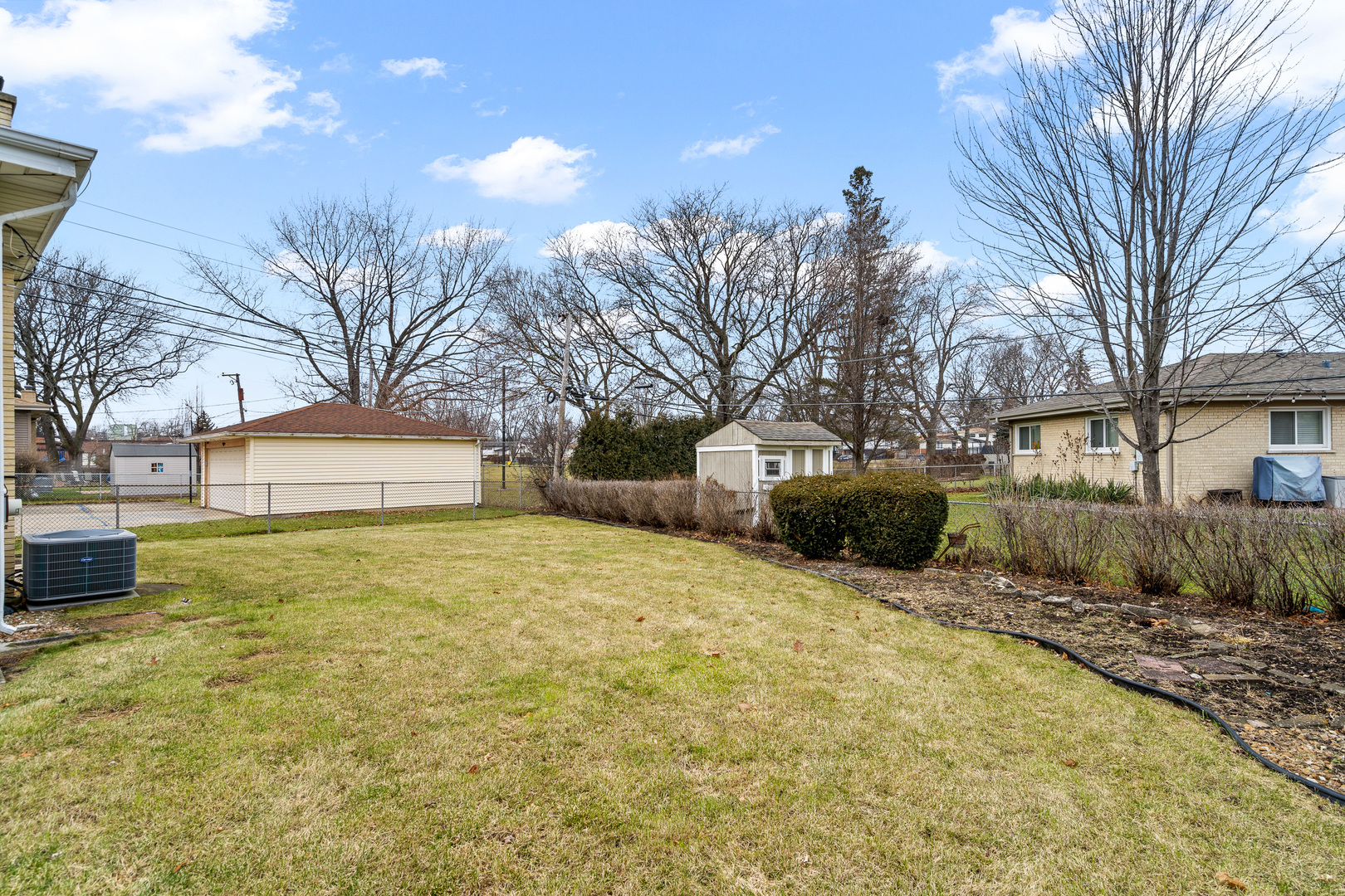 204 Dulles Road Des Plaines, IL 60016 - Photo 25 of 25 a yellow house with trees in front of it