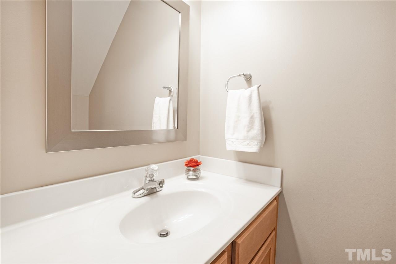 10032 Blackwell Drive Raleigh, NC 27617 - Photo 11 of 28 a bathroom with a sink vanity and a mirror