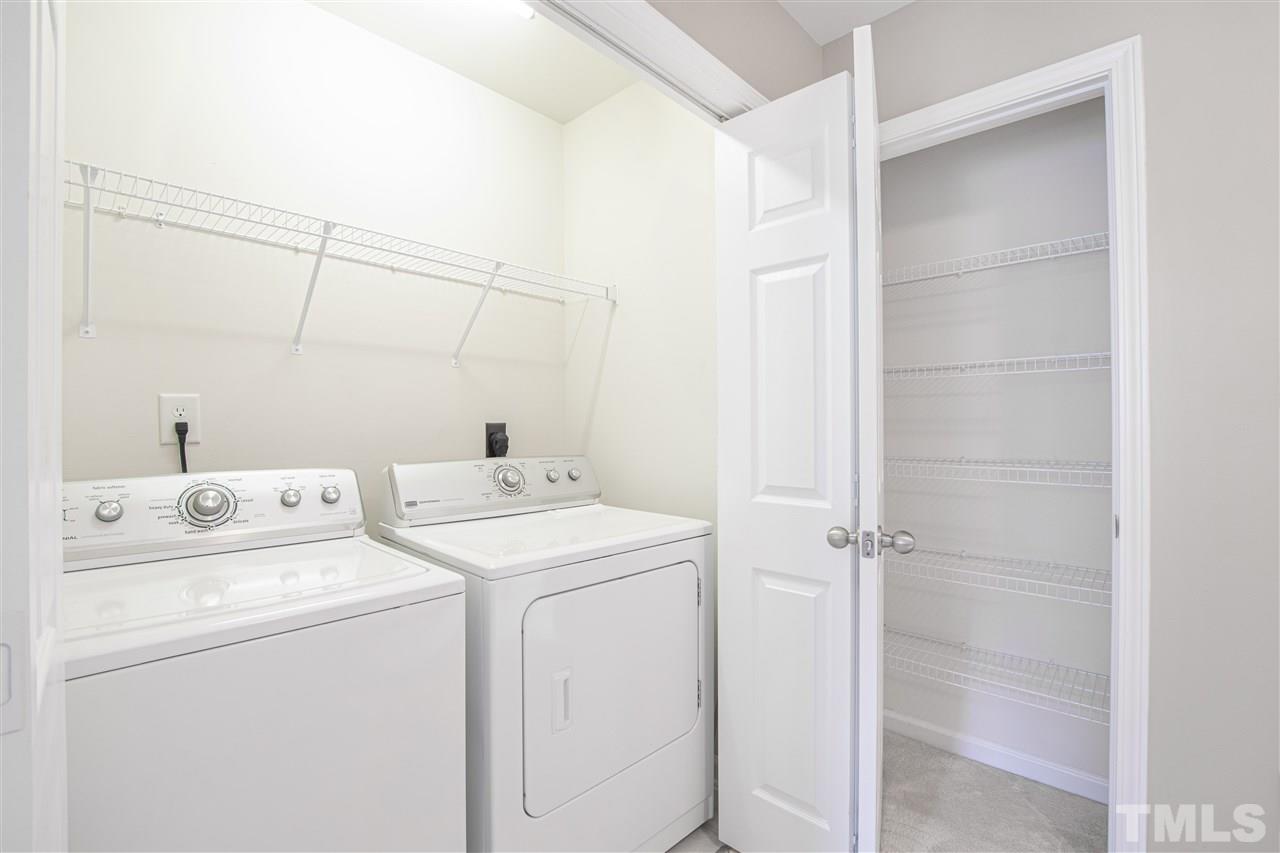 10032 Blackwell Drive Raleigh, NC 27617 - Photo 12 of 28 a view of storage and utility room with dryer and washer