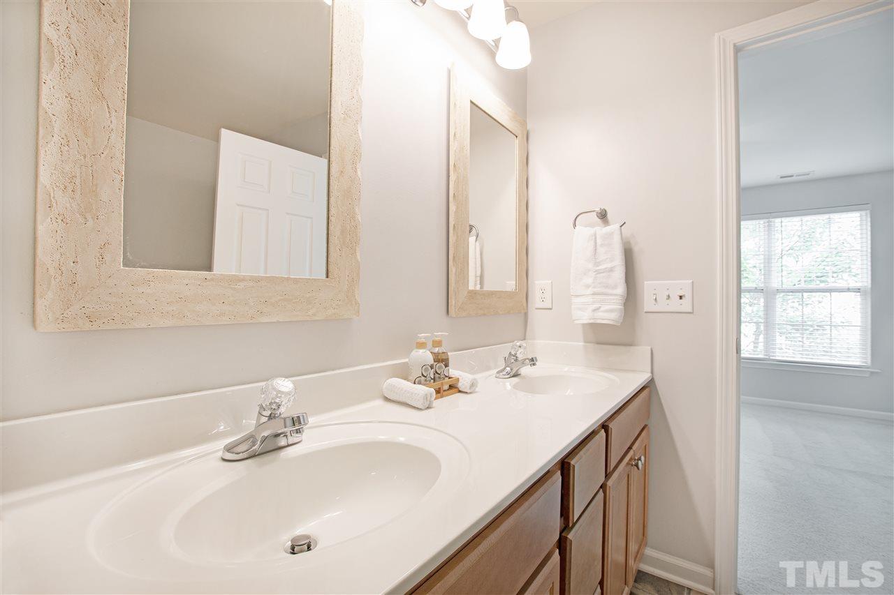 10032 Blackwell Drive Raleigh, NC 27617 - Photo 15 of 28 a bathroom with a sink and a mirror
