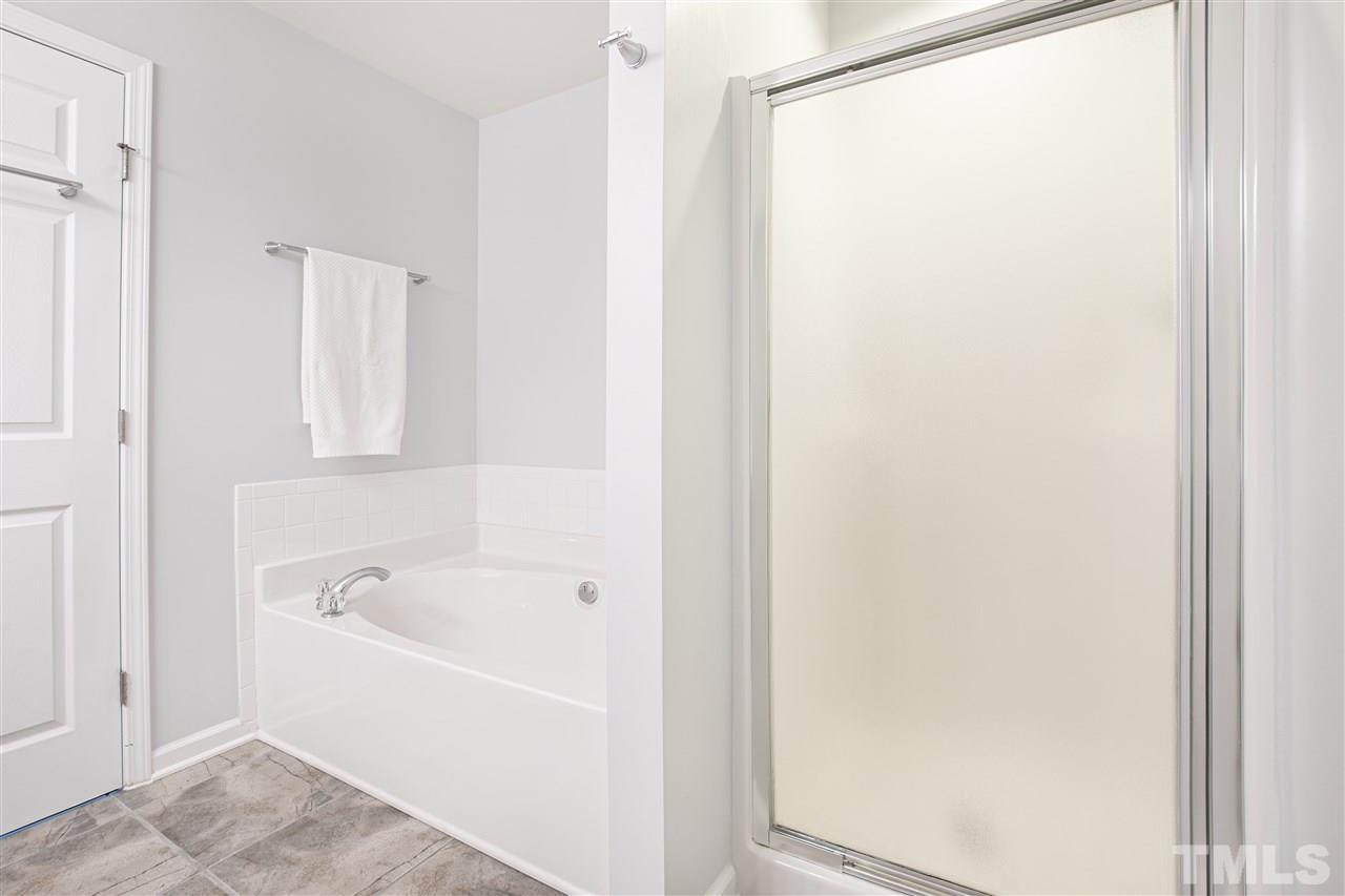 10032 Blackwell Drive Raleigh, NC 27617 - Photo 16 of 28 a white bath tub sitting next to a white sink