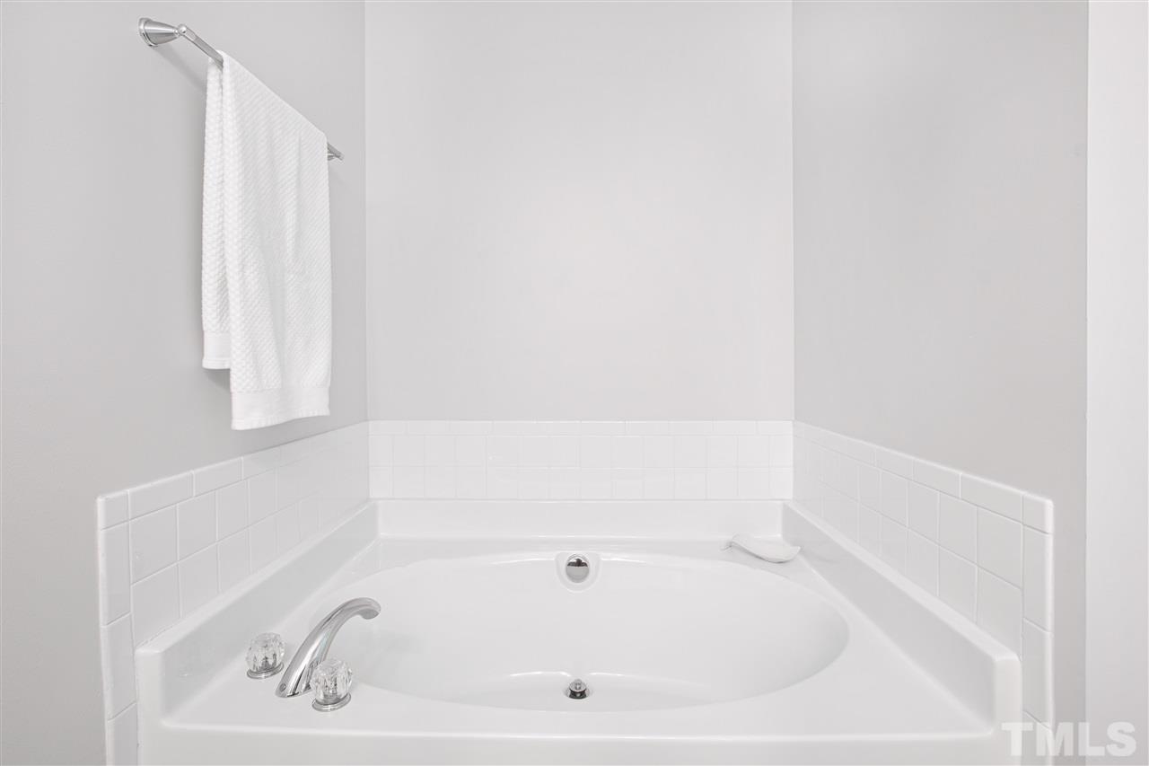 10032 Blackwell Drive Raleigh, NC 27617 - Photo 17 of 28 a white bath tub sitting next to a white sink