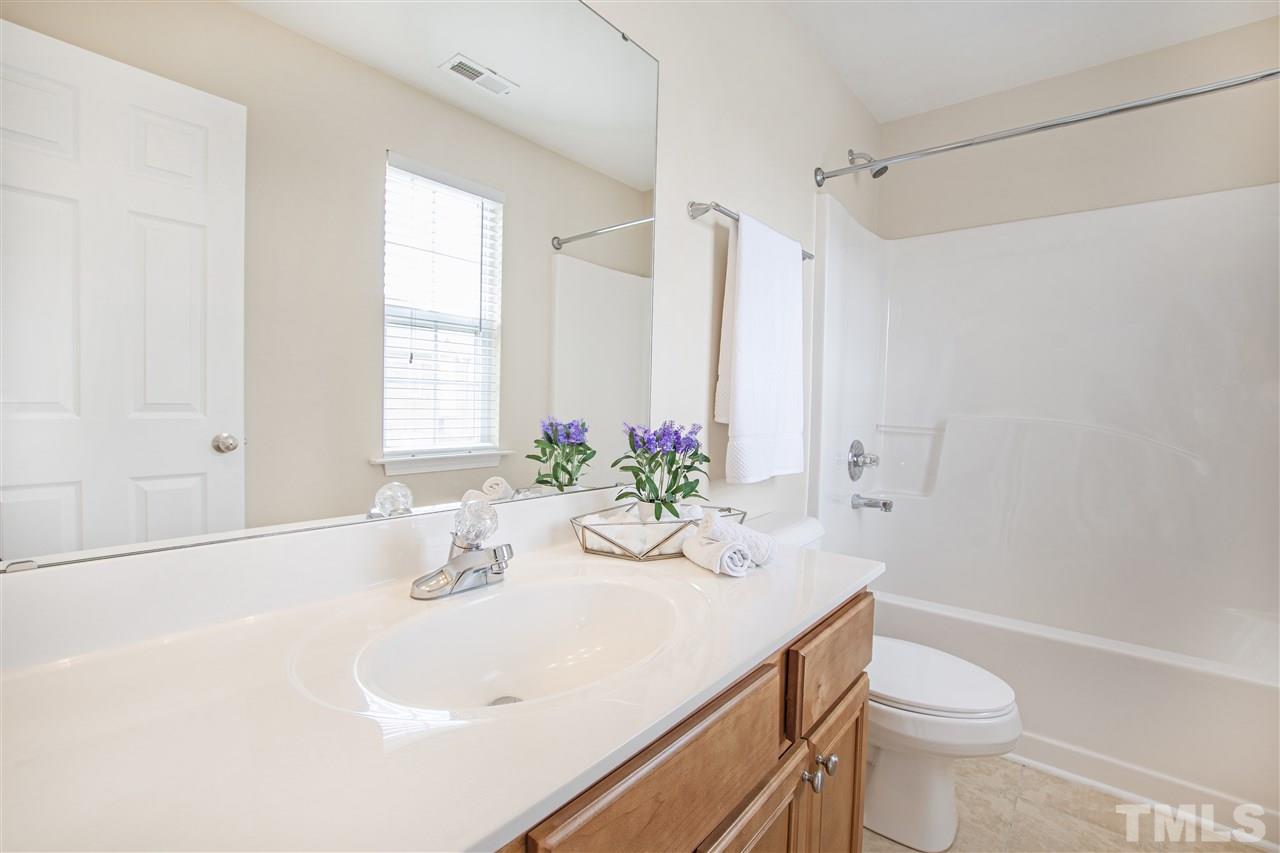10032 Blackwell Drive Raleigh, NC 27617 - Photo 23 of 28 a bathroom with a sink a toilet and tub