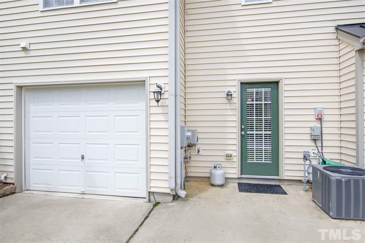 10032 Blackwell Drive Raleigh, NC 27617 - Photo 25 of 28 a view of a house with a door and wooden bench
