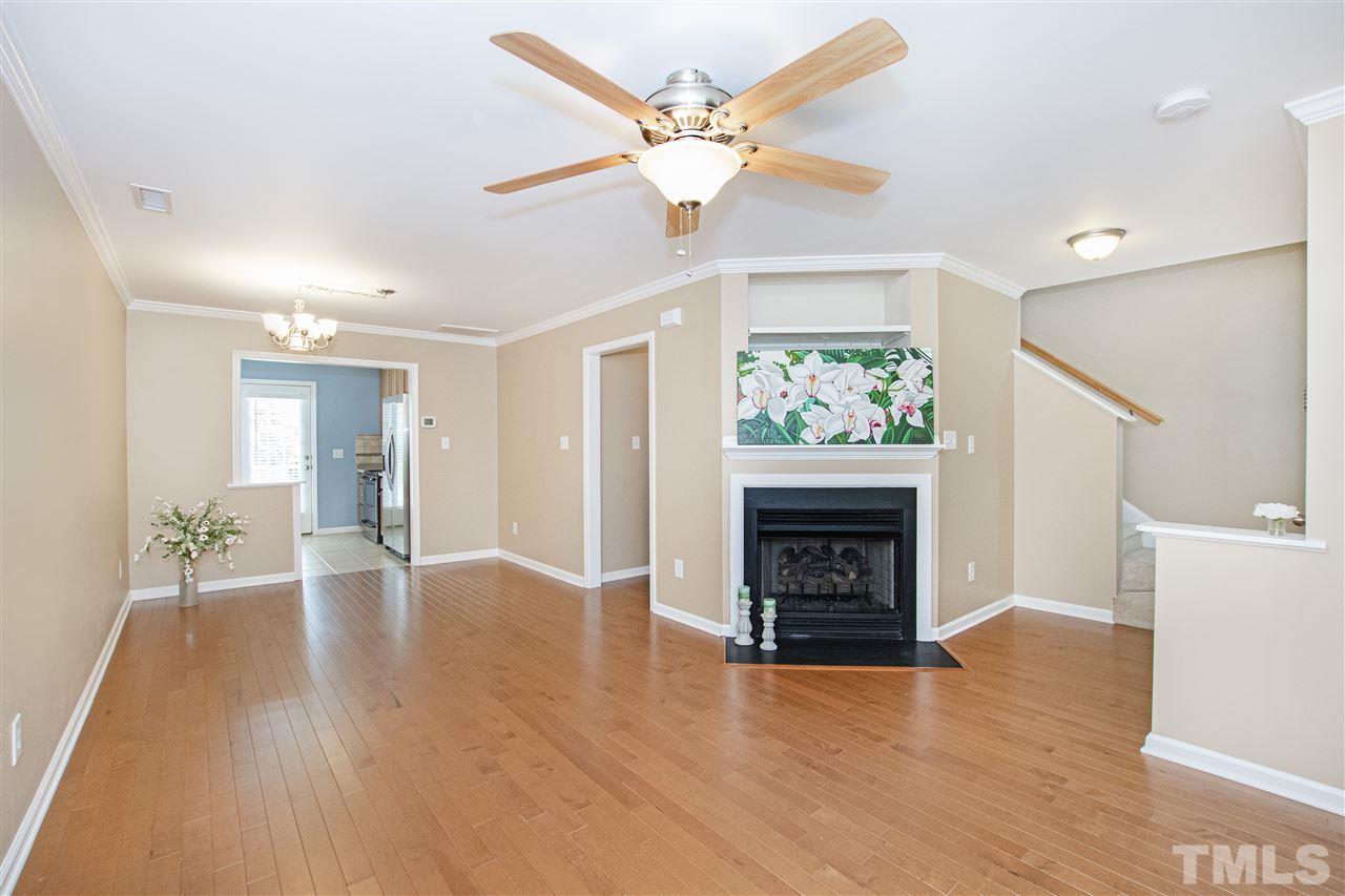 10032 Blackwell Drive Raleigh, NC 27617 - Photo 4 of 28 a view of an empty room with a fireplace and a window