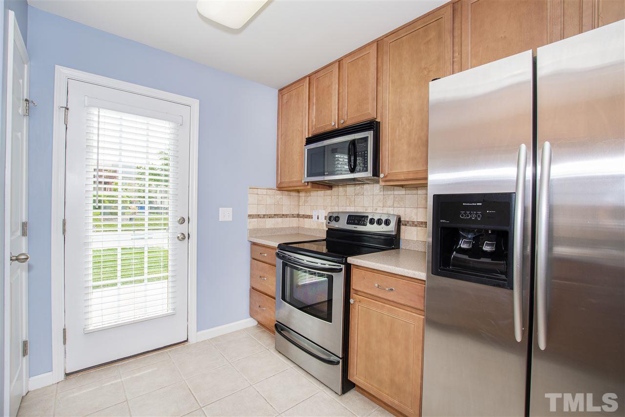 10032 Blackwell Drive Raleigh, NC 27617 - Photo 7 of 28 a kitchen with stainless steel appliances granite countertop a refrigerator a stove a sink and dishwasher