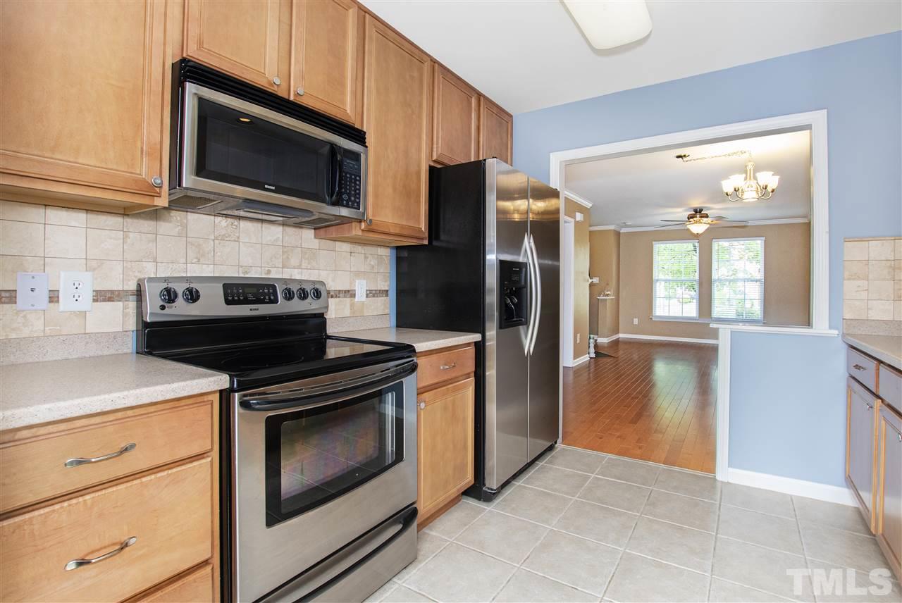 10032 Blackwell Drive Raleigh, NC 27617 - Photo 8 of 28 a kitchen with stainless steel appliances granite countertop a stove microwave and refrigerator