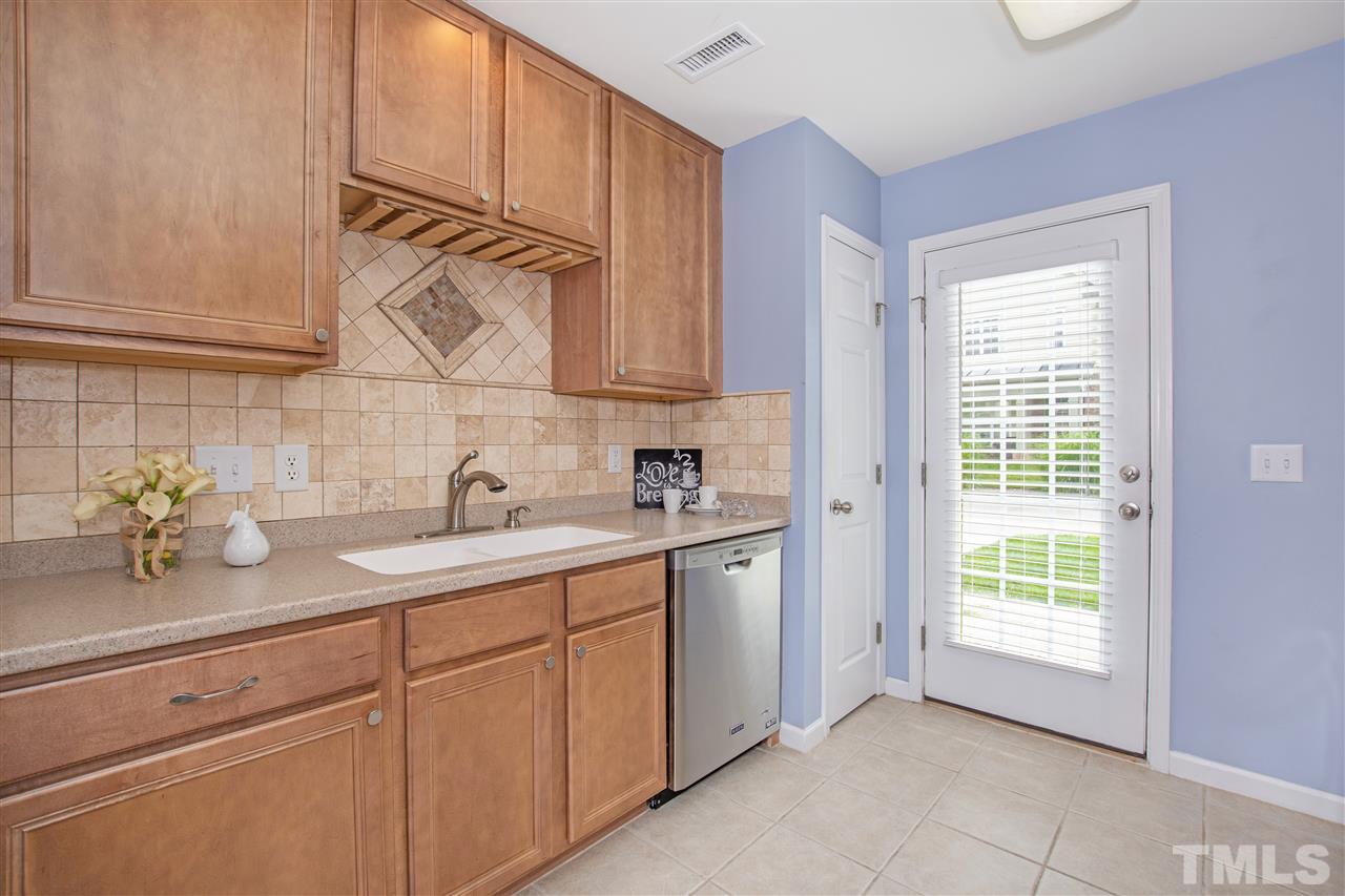 10032 Blackwell Drive Raleigh, NC 27617 - Photo 9 of 28 a kitchen with a sink cabinets and window