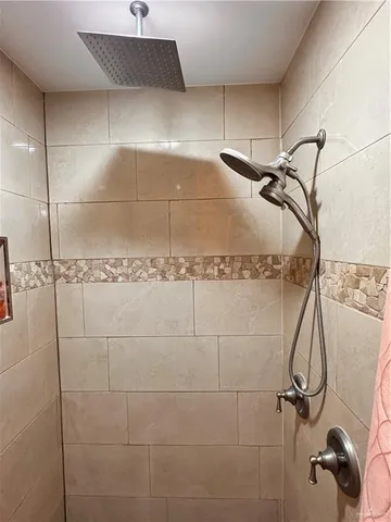 a bedroom with a bed and lamp on dresser