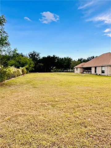 a large pool that has lawn chairs near an ocean