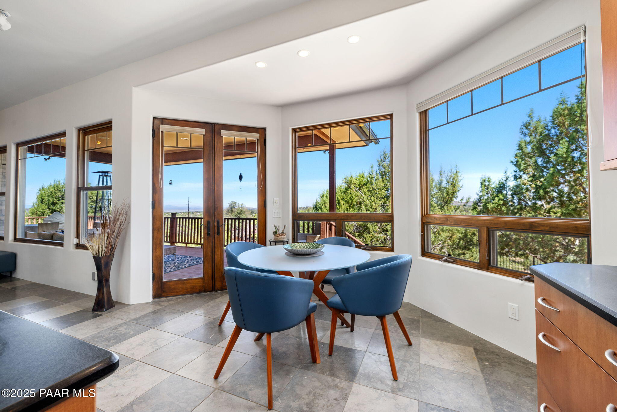 13175 North Bull Run Road Prescott, AZ 86305 - Photo 24 of 60 a dining room with furniture and a floor to ceiling window