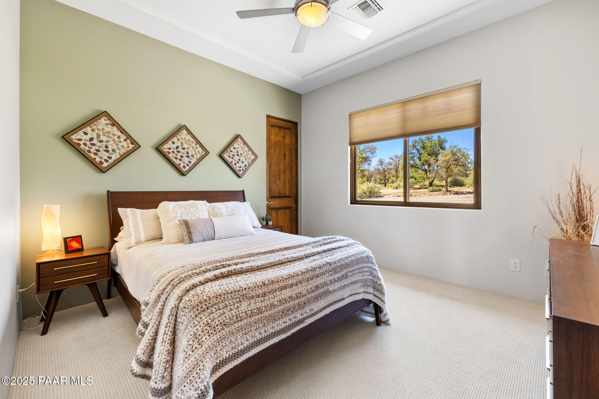 13175 North Bull Run Road Prescott, AZ 86305 - Photo 36 of 60 a bedroom with a bed and a chandelier