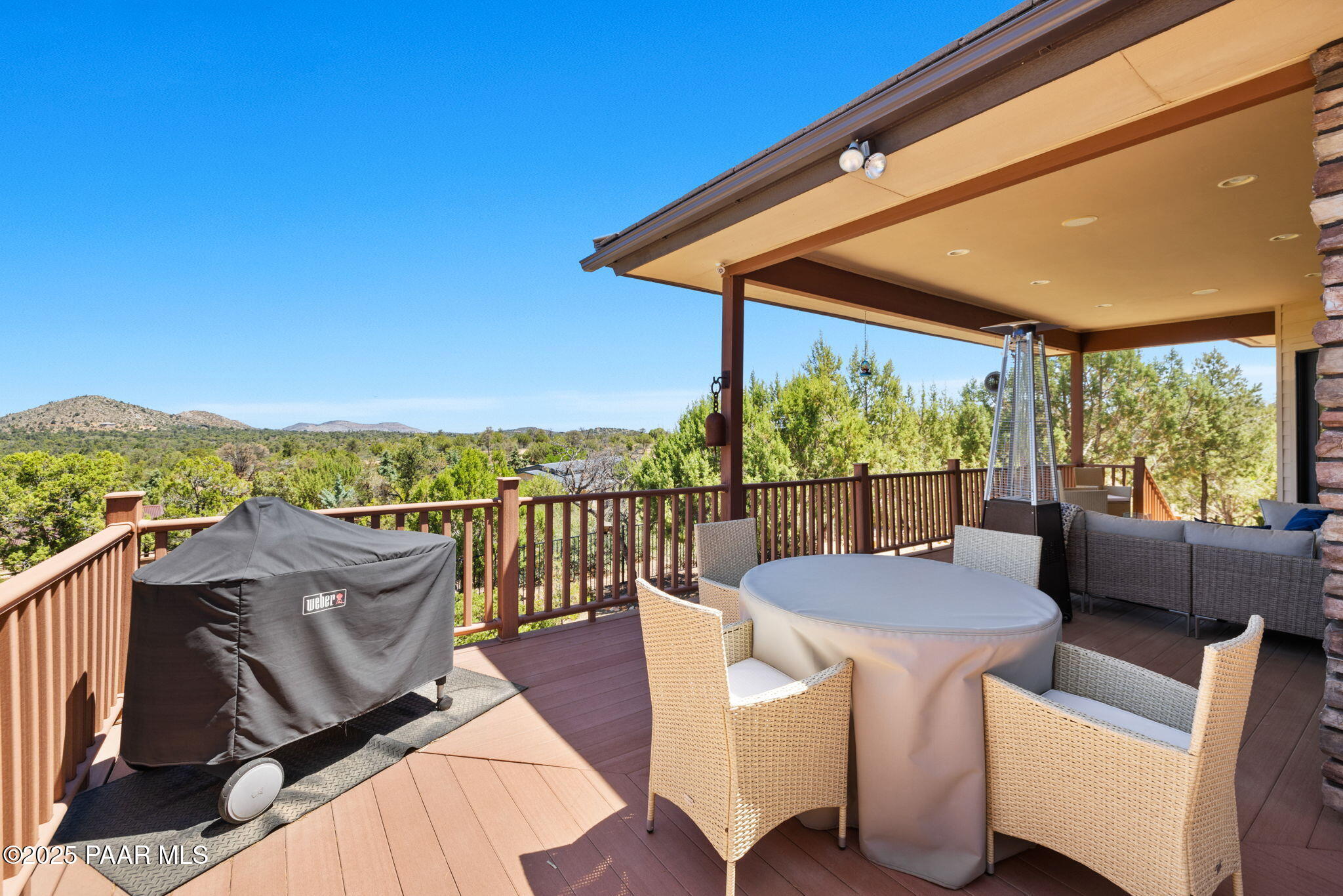 13175 North Bull Run Road Prescott, AZ 86305 - Photo 40 of 60 a view of a patio with couches chairs potted plants and wooden floor