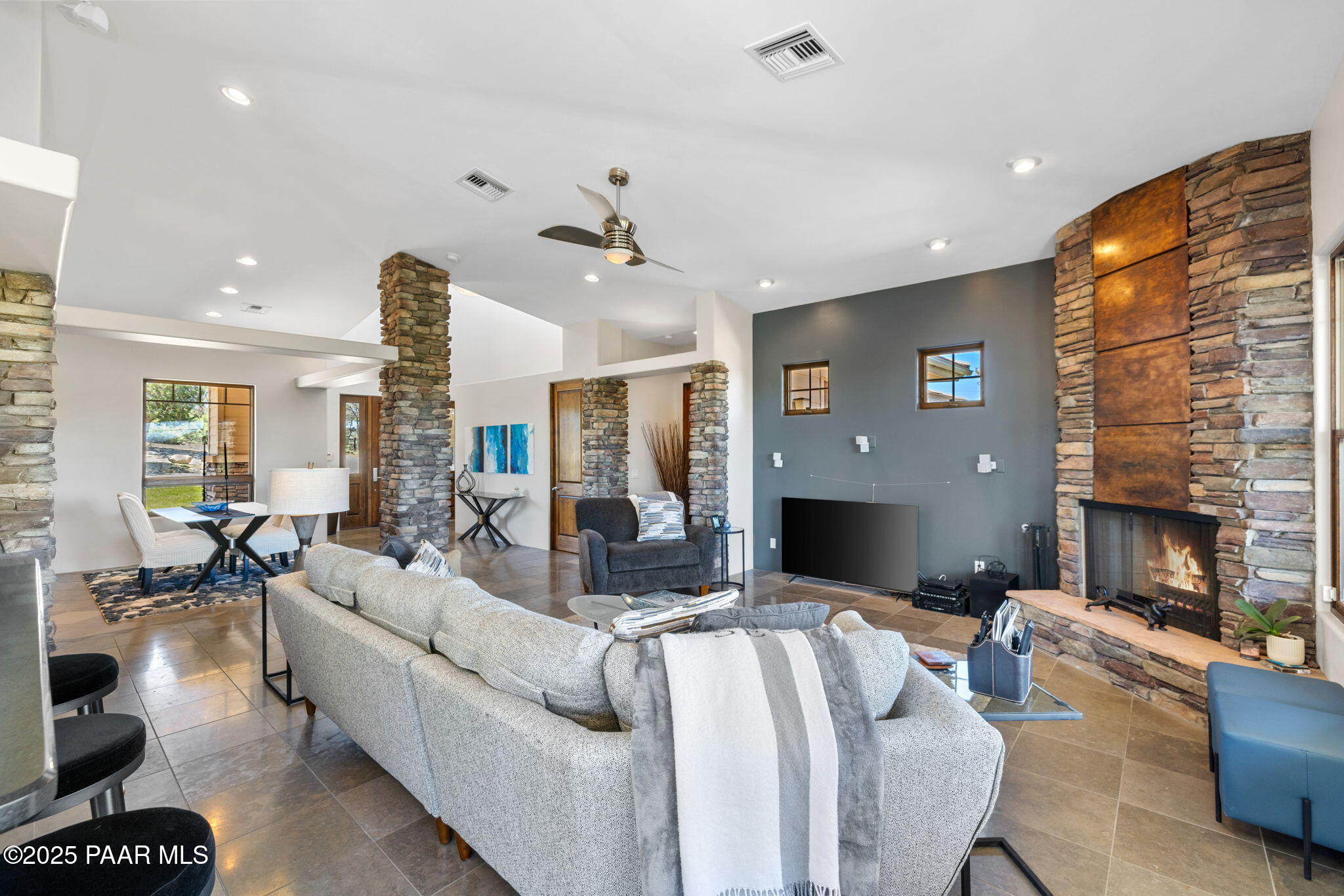 13175 North Bull Run Road Prescott, AZ 86305 - Photo 9 of 60 a living room with furniture a fireplace and a flat screen tv