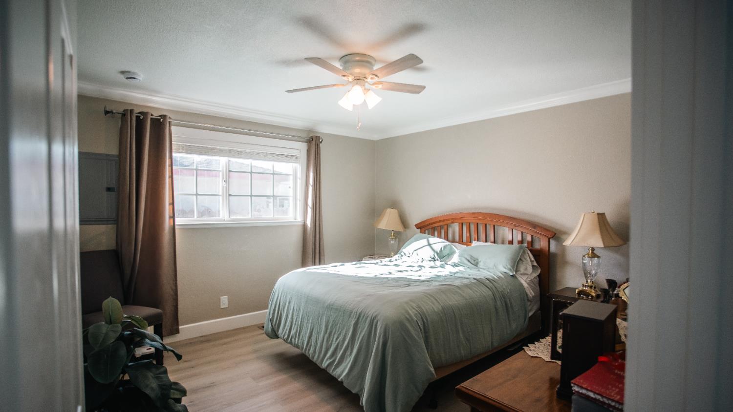 9115 East Southland Road Manteca, CA 95336 - Photo 12 of 52 a bedroom with a bed and a chandelier