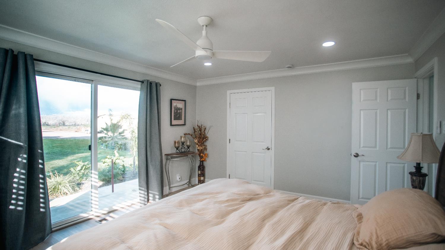 9115 East Southland Road Manteca, CA 95336 - Photo 14 of 52 a bedroom with a large bed and a large window