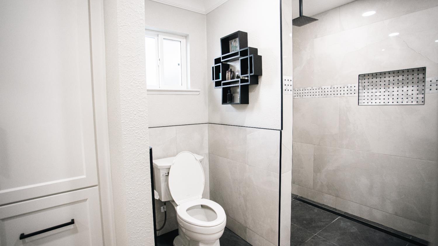 9115 East Southland Road Manteca, CA 95336 - Photo 16 of 52 a white toilet sitting next to a bathroom sink