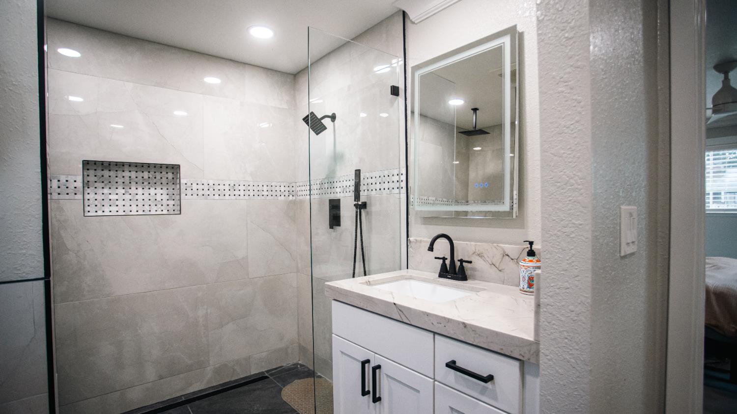 9115 East Southland Road Manteca, CA 95336 - Photo 17 of 52 a bathroom with a sink a light fixture and a mirror