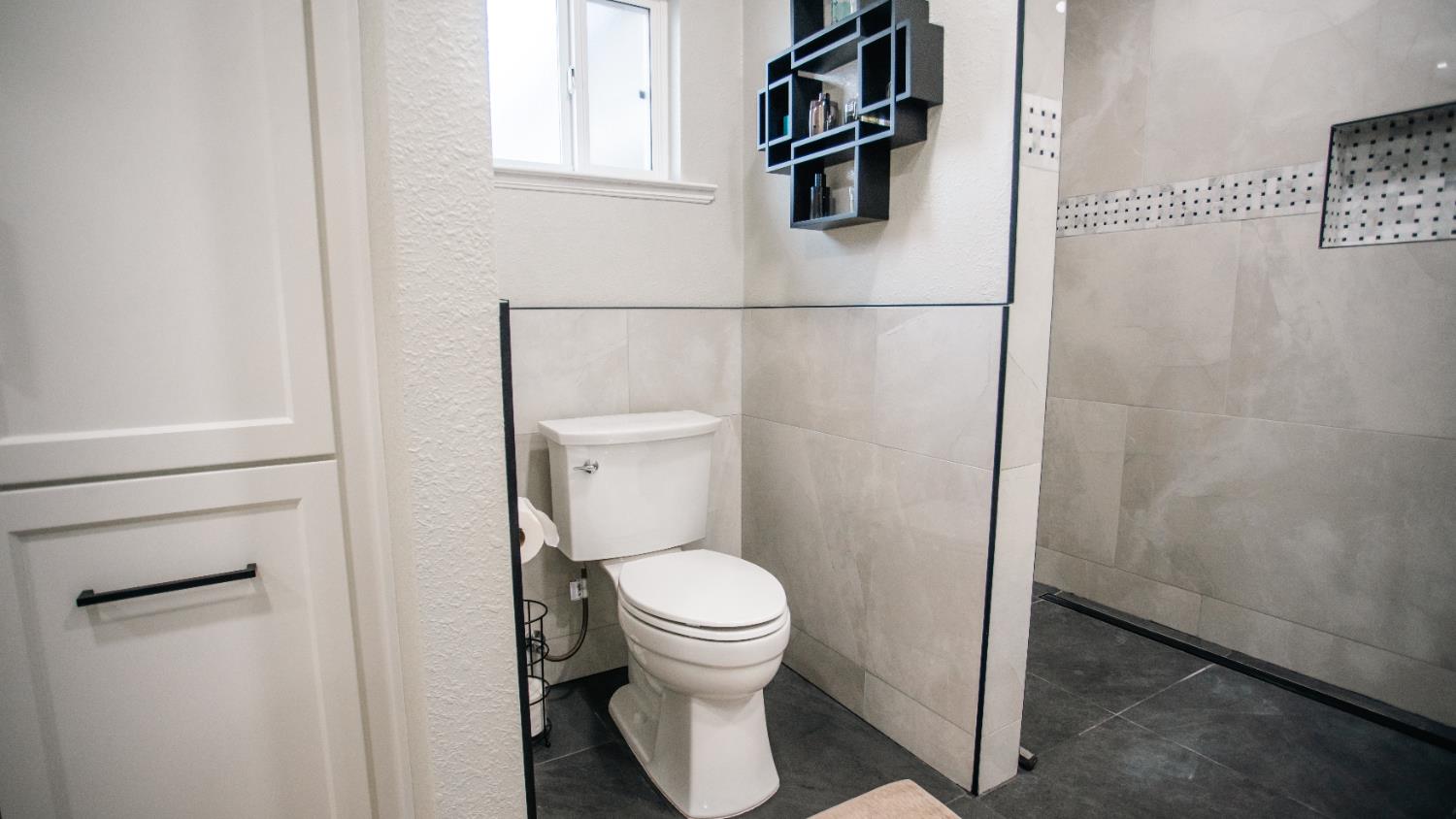 9115 East Southland Road Manteca, CA 95336 - Photo 19 of 52 a white toilet sitting next to a bathroom sink