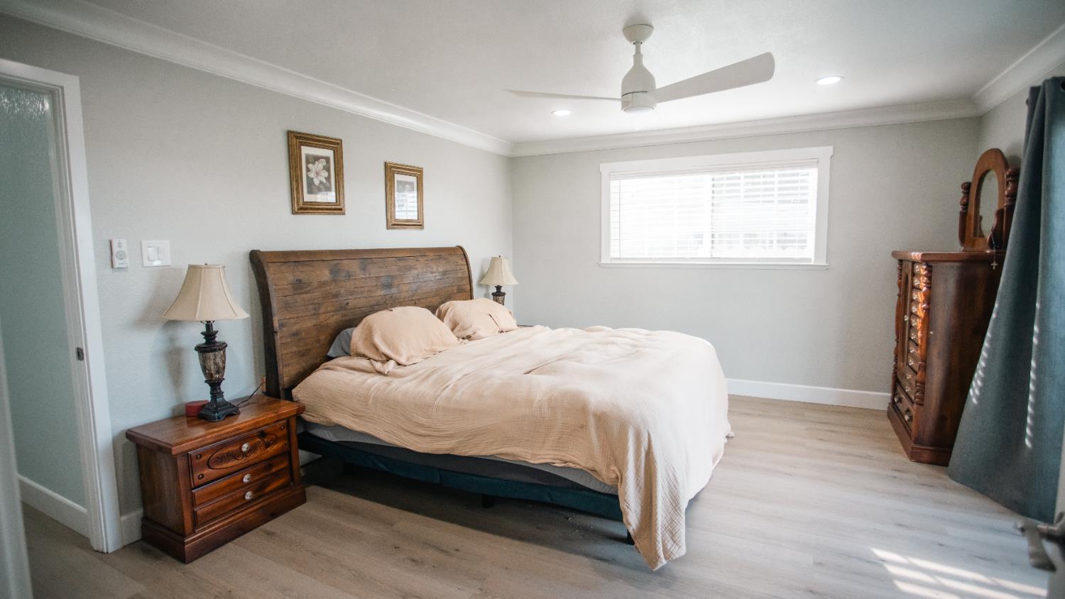 9115 East Southland Road Manteca, CA 95336 - Photo 21 of 52 a bedroom with a bed and a flat tv screen on the dresser