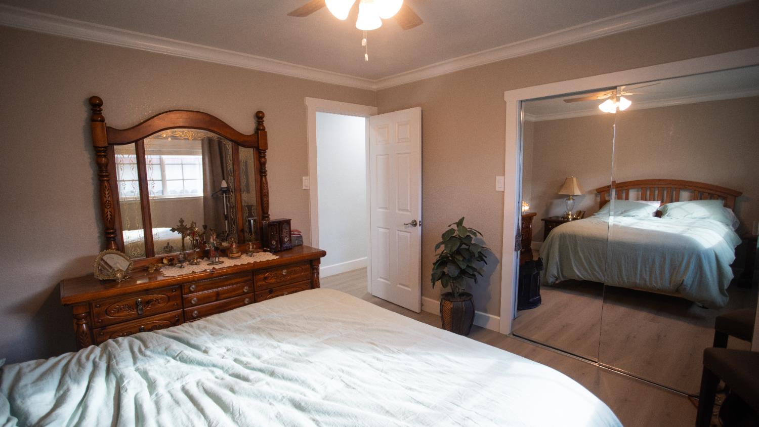 9115 East Southland Road Manteca, CA 95336 - Photo 23 of 52 a bedroom with a bed and a mirror on dresser