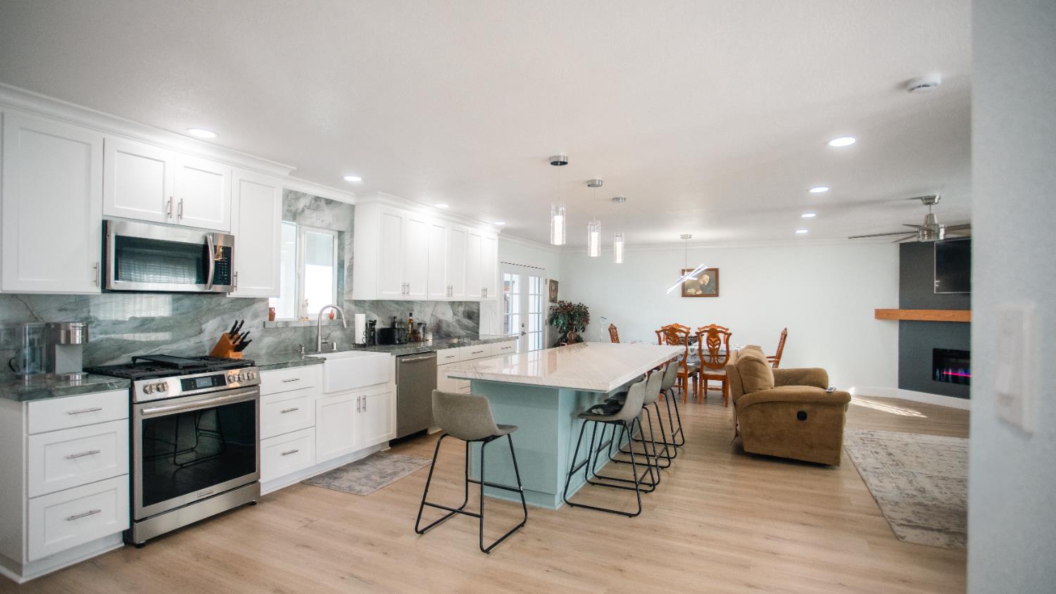 9115 East Southland Road Manteca, CA 95336 - Photo 27 of 52 a kitchen with stainless steel appliances kitchen island granite countertop a sink and cabinets