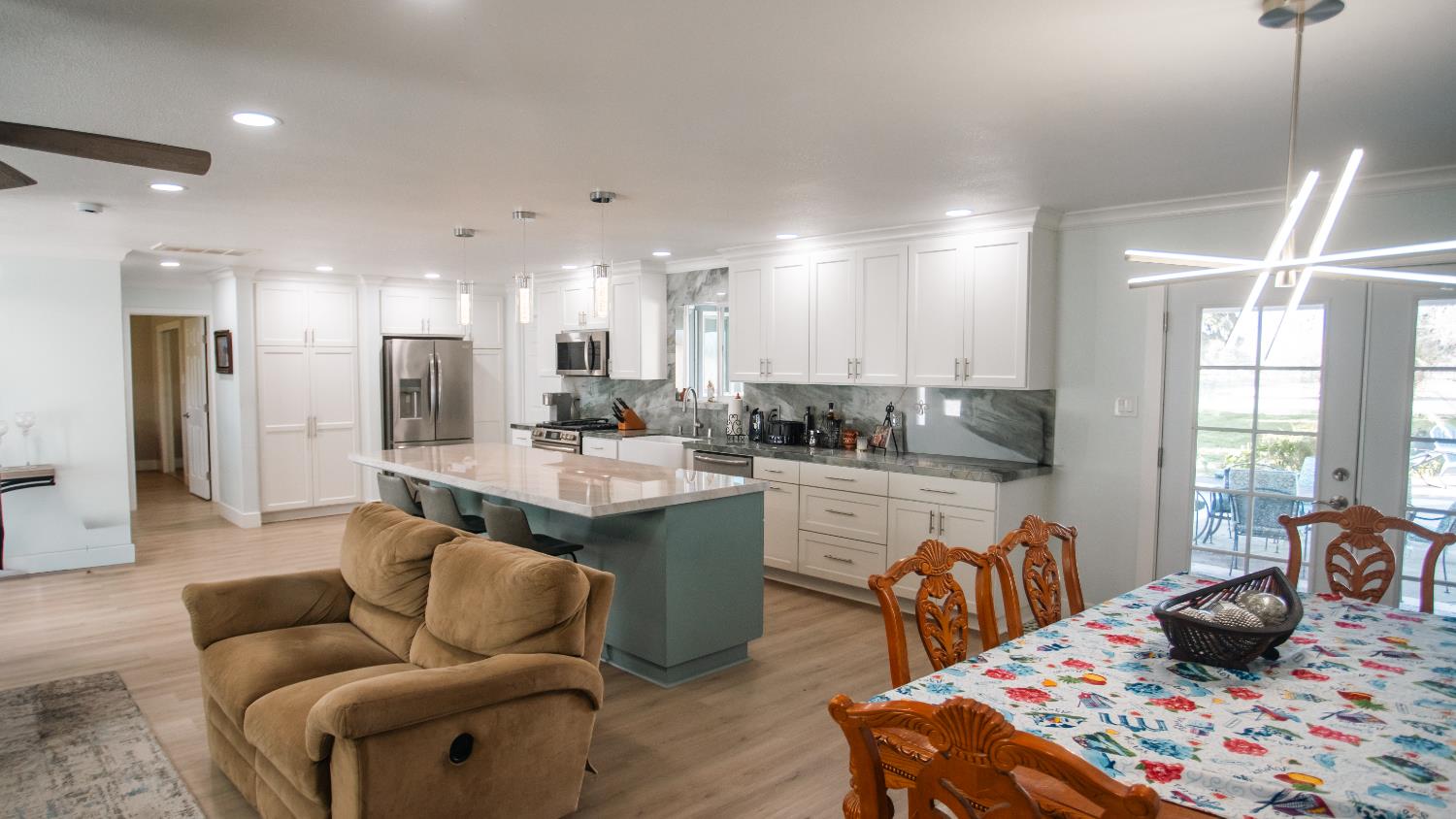 9115 East Southland Road Manteca, CA 95336 - Photo 30 of 52 a kitchen with stainless steel appliances granite countertop sink stove and refrigerator