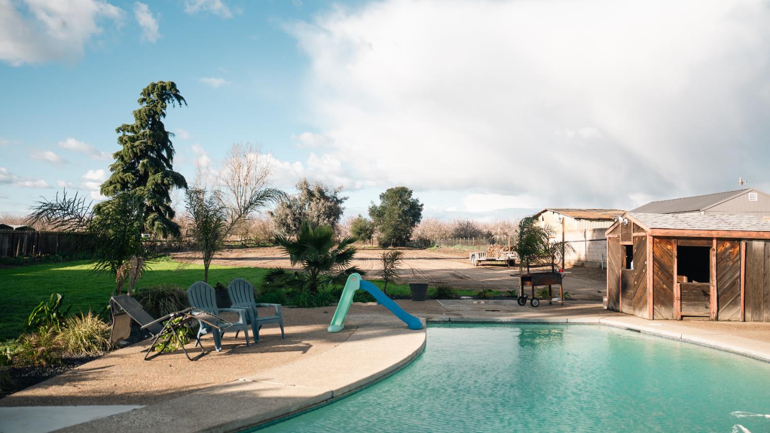 9115 East Southland Road Manteca, CA 95336 - Photo 33 of 52 a view of a swimming pool and lounge chairs