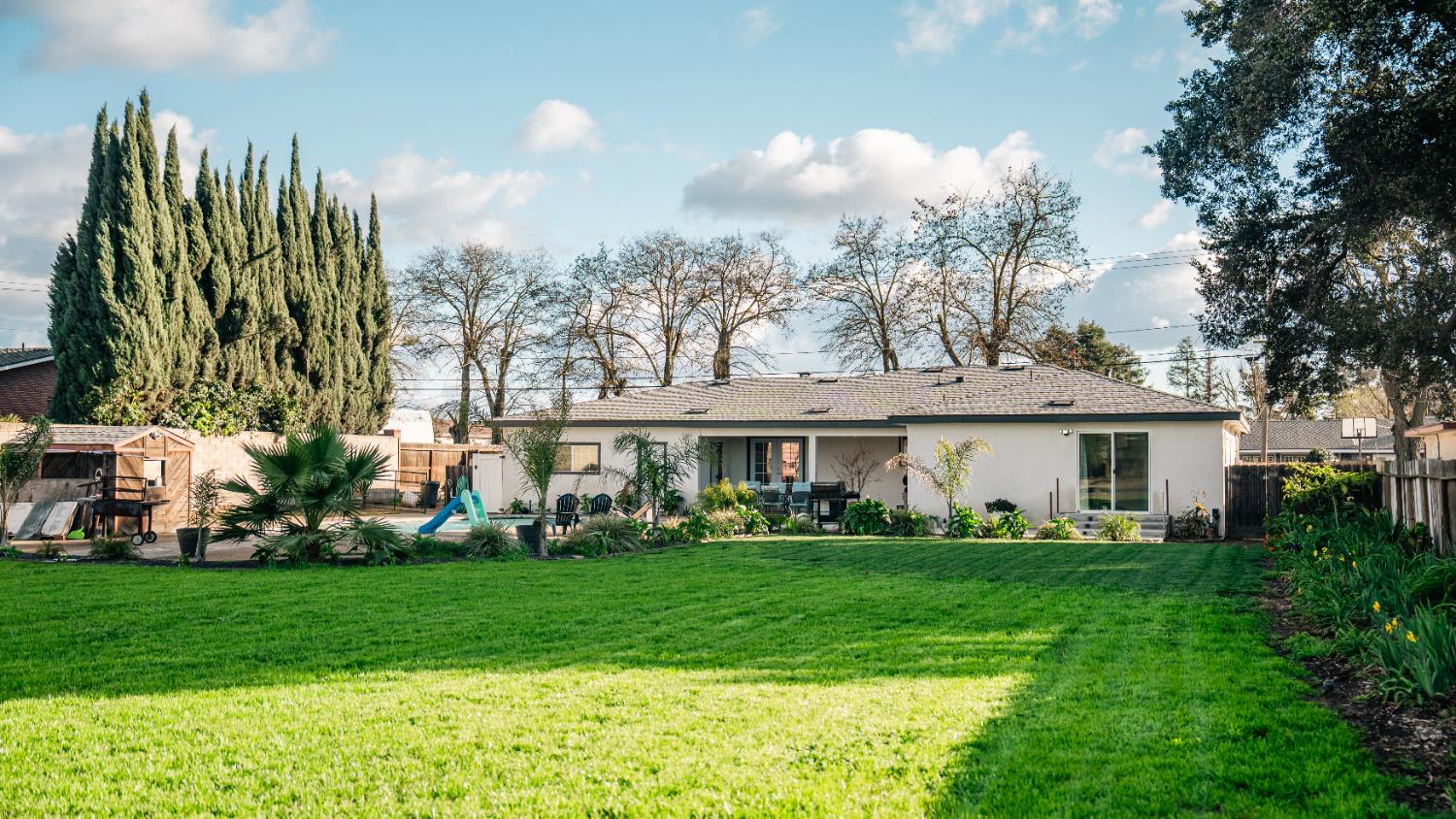 9115 East Southland Road Manteca, CA 95336 - Photo 39 of 52 a front view of a house with a garden and trees