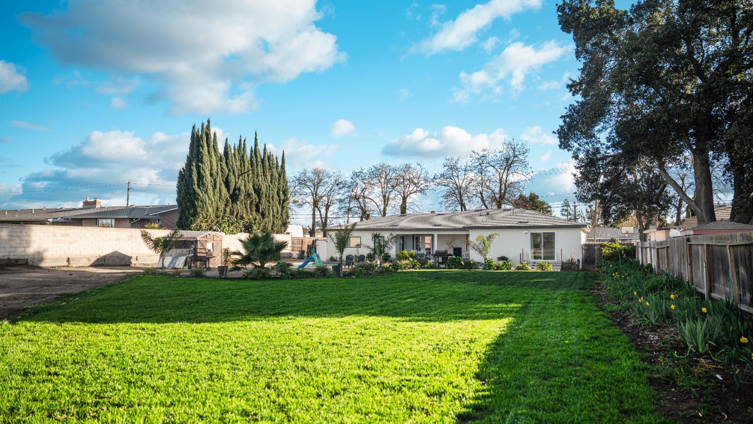 9115 East Southland Road Manteca, CA 95336 - Photo 41 of 52 a view of a house with a big yard and potted plants