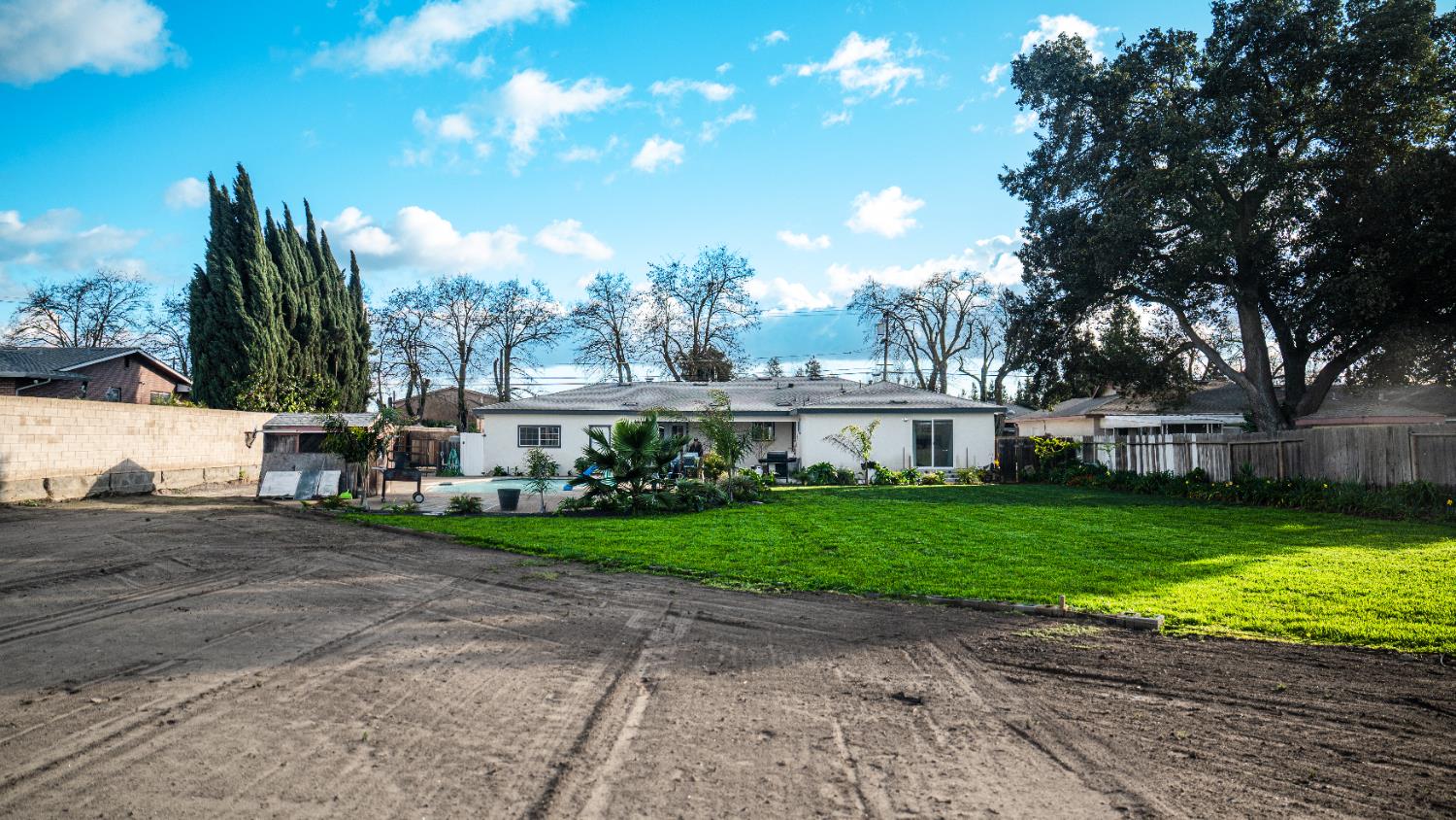 9115 East Southland Road Manteca, CA 95336 - Photo 43 of 52 a view of a big house with a big yard and large trees