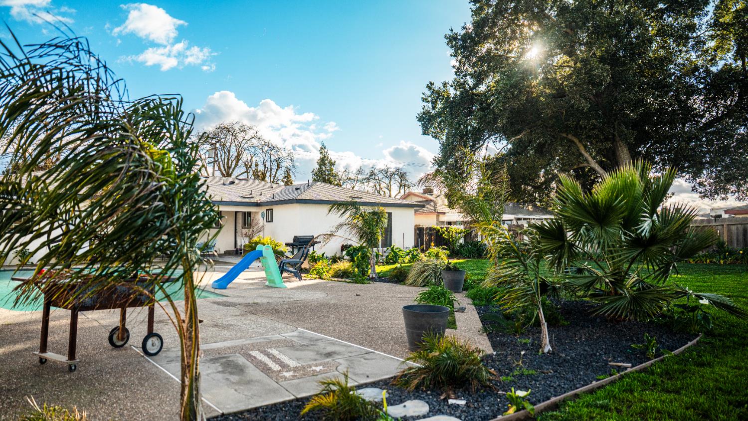 9115 East Southland Road Manteca, CA 95336 - Photo 45 of 52 a front view of a house with a yard and potted plants